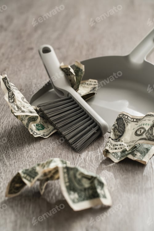 Preview: Dustpan and brush alongside scattered one-dollar bills on the floor