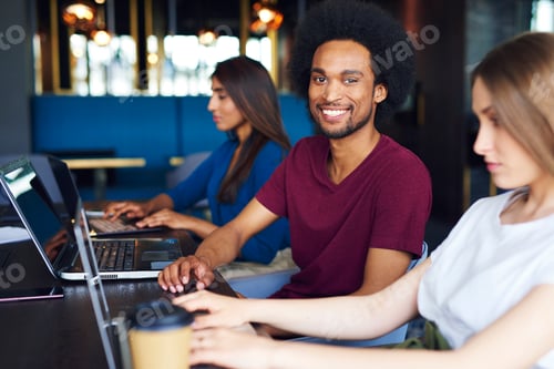 Preview: Portrait of smiling African man during business meeting