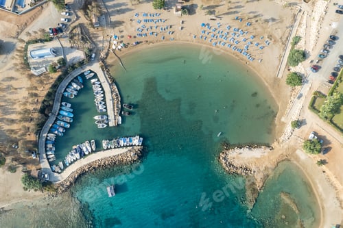 Preview: Aerial drone view of fishing harbour and sandy holiday beach for swimming.