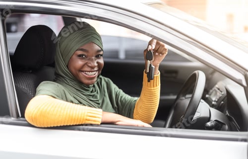 Preview: Happy Young Woman Holding Car Keys Inside Vehicle