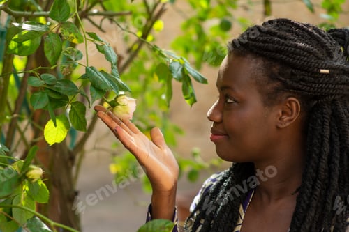 Preview: Close-up portrait Young beautiful afro american woman wearing summer outfit in the garden enjoy