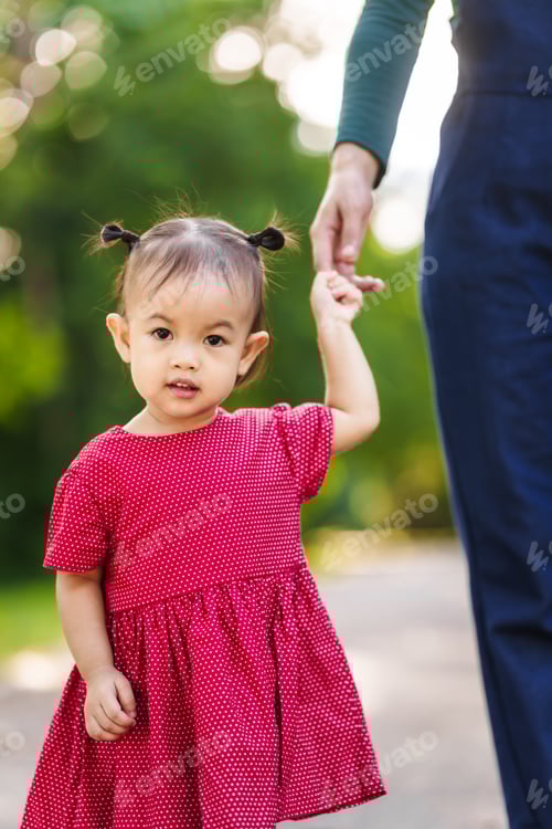 Preview: Asian mom and daughter enjoying nature in park outdoorsunlight, heartwarming bond, family time