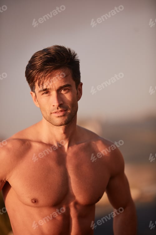 Preview: How you doin. Portrait of a handsome shirtless man working out outside.