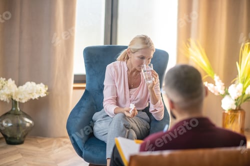 Preview: Woman drinking water while feeling emotional sharing problems