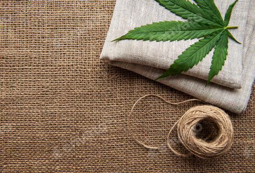 Preview: Cannabis leaves on the hemp textile background