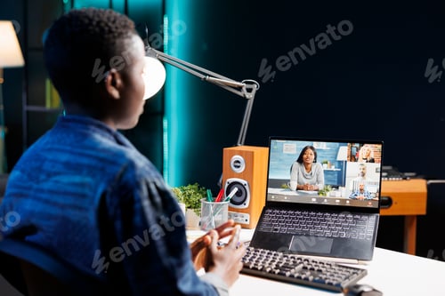 Preview: Woman video conferencing on laptop