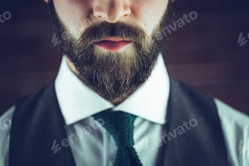 Preview: Midsection of serious man against wall