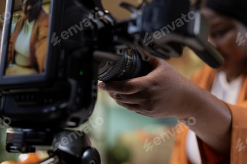 Preview: Close up, african american woman, fine tuning settings, fixing camera on tripod