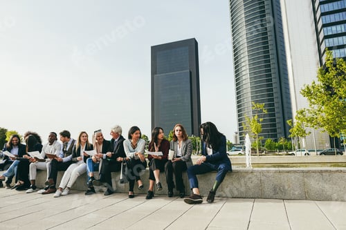Preview: Multiethnic business people working outdoor from office - Main focus on right girl face