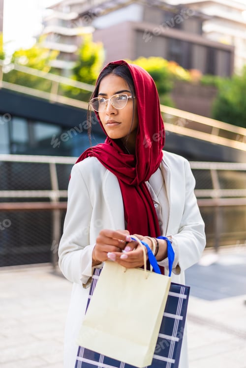 Preview: Beautiful muslim girl wearing hijab bonding outdoors
