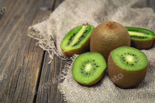 Preview: Close -up, cut fruit kiwi on a wooden background, rustic style.