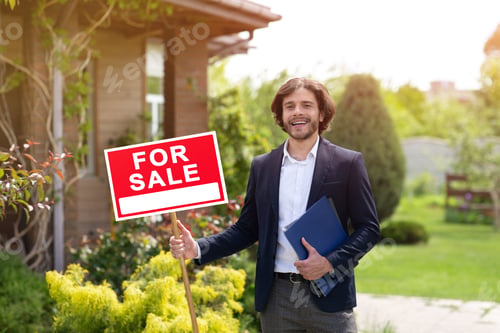 Preview: Happy real estate agent holding FOR SALE sign near residential building outdoors