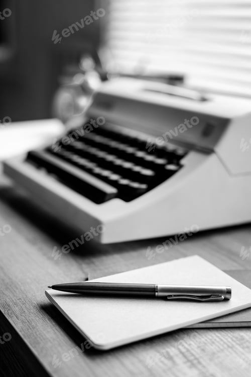 Preview: Pen and notepad with vintage typewriter on wood desk table. Writer or study creative concept