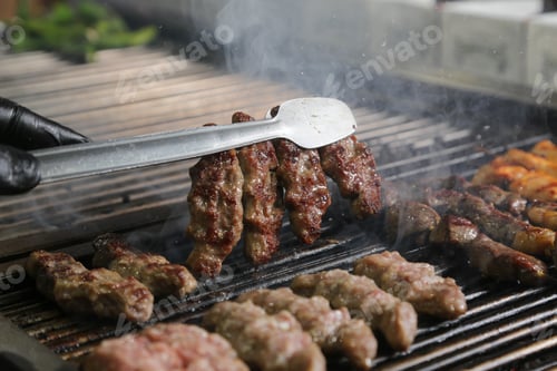 Preview: side view meat cutlets on a barbecue