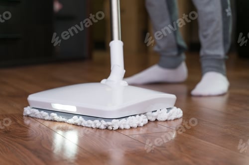 Preview: A man washes the floor in an apartment with a modern electric mop