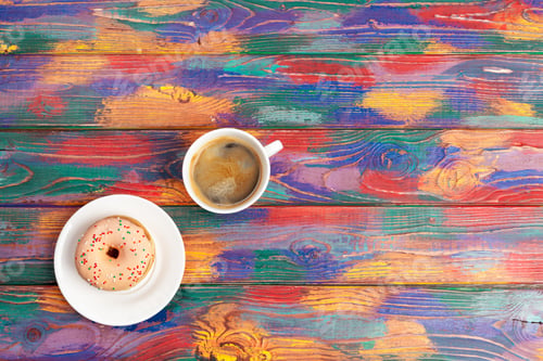 Preview: fresh donut with coffee on wooden surface, top view