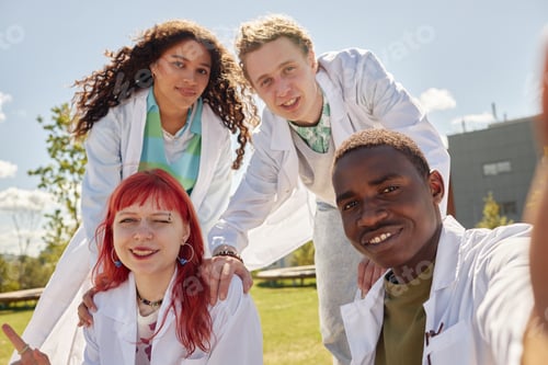 Preview: Selfie of Four Young Med Students of Diverse Ethnicity Outdoors on Campus