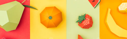 Preview: panoramic shot of various origami fruits on multicolored paper stripes