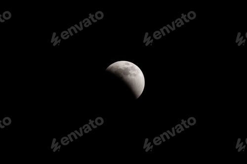 Preview: Lunar eclipse full crescent super moon rising against the dark sky