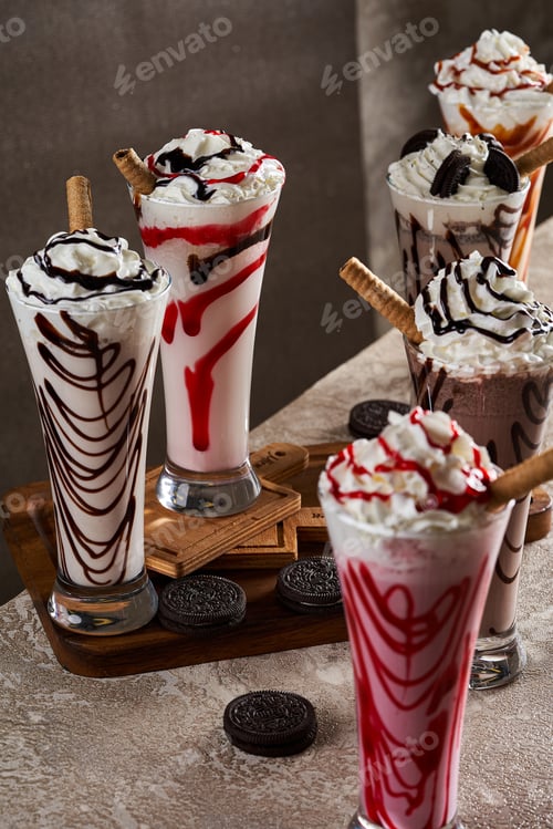 Preview: A cup of milkshakes with different flavors on a wooden floor