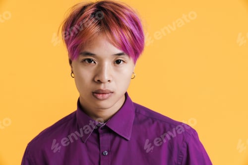 Preview: Asian boy with pink hair posing and looking at camera