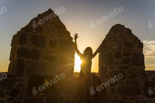 Preview: A young man sitting on a sunset on the walls, Ávila, Castilla y Leon. Spain