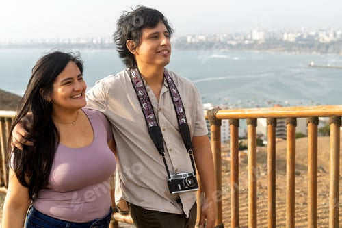 Preview: Young couple enjoying city ocean view during vacation