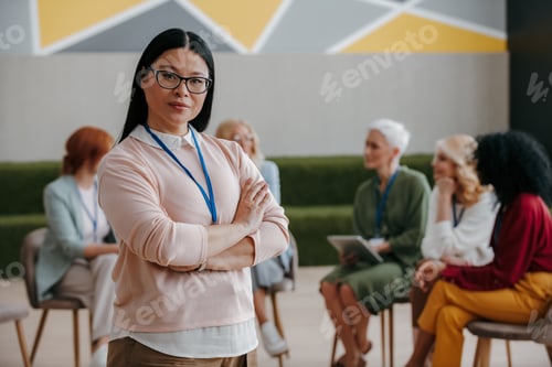 Preview: Confident Asian woman looking at camera while visiting group training class for females