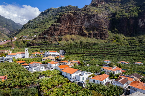 Preview: Aerial view of small farming village with banana plantation at Madeira Atlantic Ocean coast