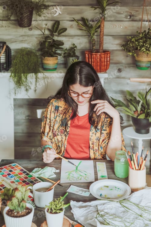 Preview: Young woman painting plants with water colors