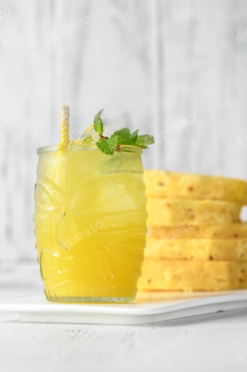 Refreshing Pineapple Drink with Mint Leaves on Counter