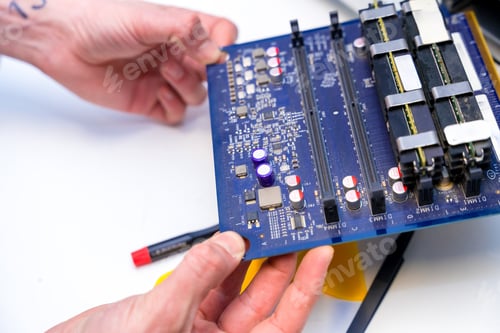 Preview: Technician holding an electronic component of computer in a workshop