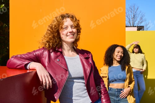 Preview: Young women smiling and having fun against colorful background