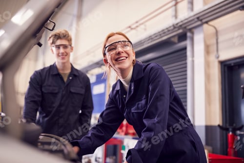 Preview: Male And Female Students Looking At Car Engine On Auto Mechanic Apprenticeship Course At College