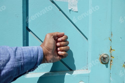 Preview: young man hand knocking door,