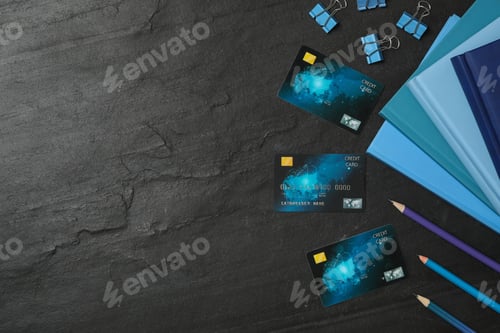 Preview: Credit cards and stationery on black background, flat lay. Space for text
