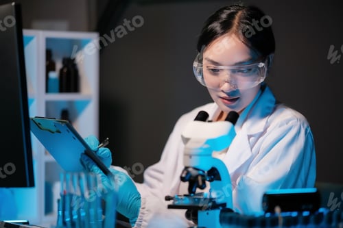 Preview: Asian female scientist looking under microscope, analyzes petri dish sample. specialists working on