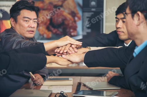 Preview: Group of business people meeting in conference room brainstorming consult business document