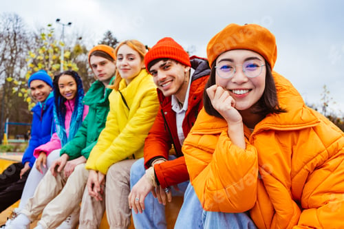 Preview: Multiracial group of young friends meeting outdoors in winter