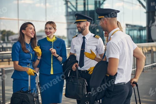 Preview: Cheerful airline workers talking on the street