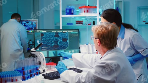 Preview: Senior biochemist writing on computer the changes in vaccine