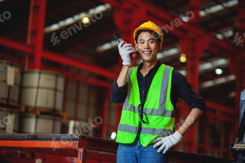 Preview: Confident Asian engineer inspecting steel industry production in factory