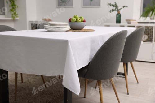 Preview: Table with white tablecloth, apples, plates and chairs in stylish room
