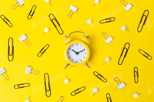 Preview: Top view of yellow oclock with black and white stationery around.Back to school concept.