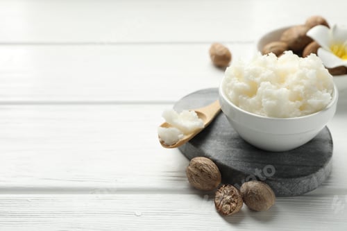Preview: Natural shea butter on white wooden table, closeup. Space for text