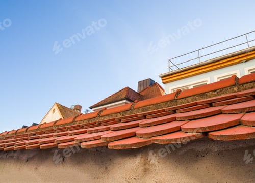 Preview: edge of an antique tiled roof, red tiles