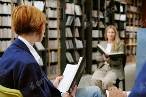 Preview: Caucasian Middle Aged Women Discussing Book during Presentation in Library