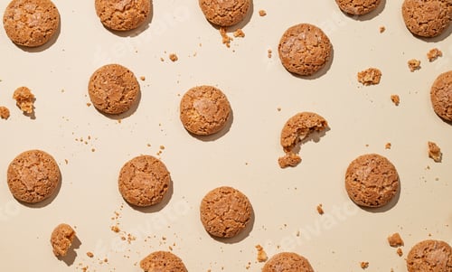 Preview: Flat lay of amaretti cookies on beige background with shadow.