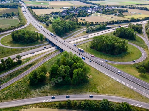Preview: Top view of cars driving on round intersection in city. Aerial view of road in Germany