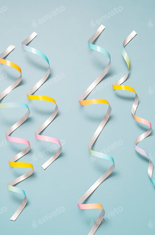 Preview: Colorful curled paper ribbons on pastel blue background.